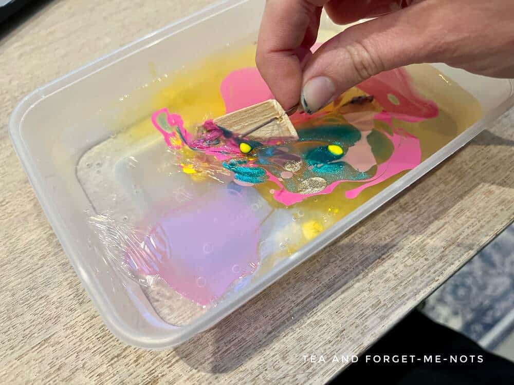 Hydro dipping earrings into nail polish