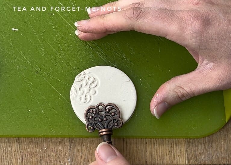Impressing pattern into clay with key