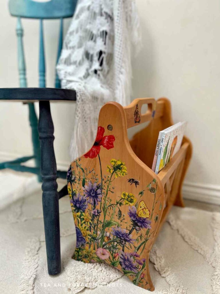 image shows a magazine rack made over with a floral furniture transfer.