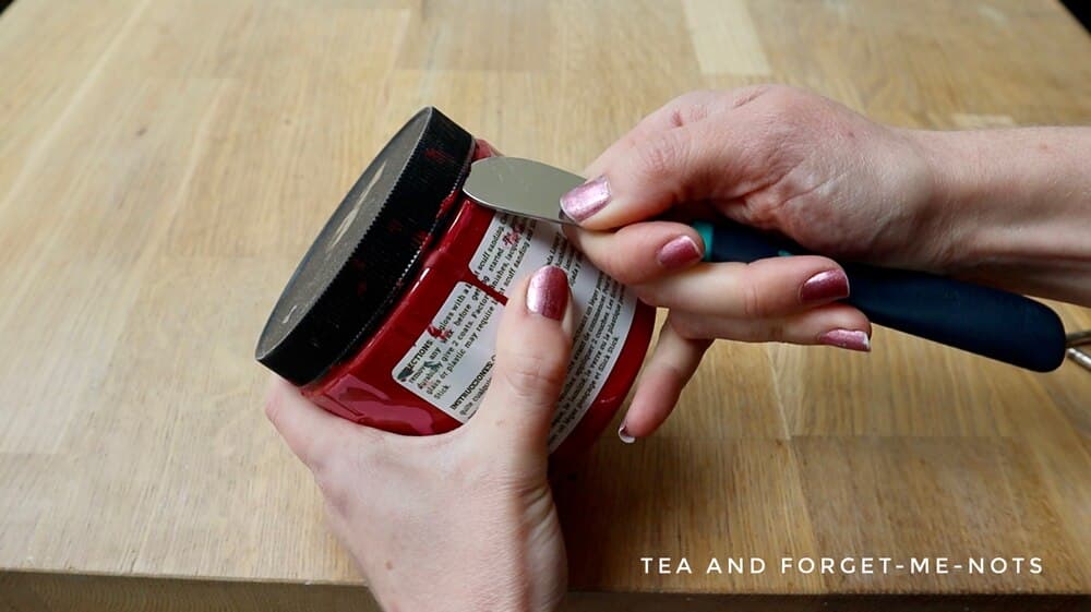 Remove paint lid with a butter knife