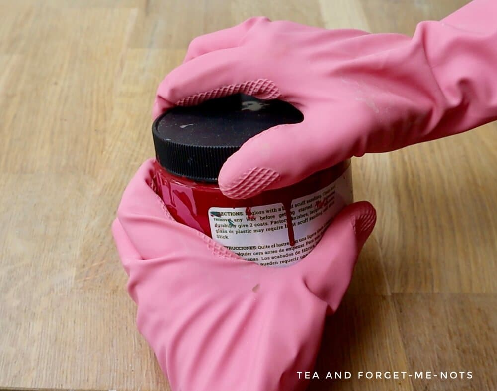 Remove stuck paint can lid using rubber gloves