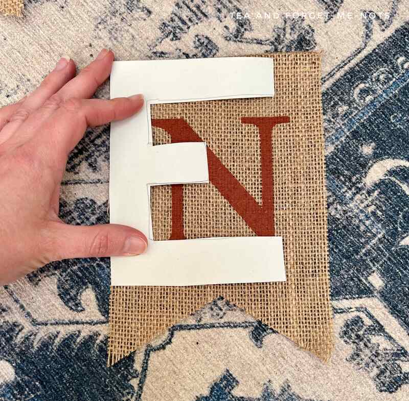 The letter stencil over the burlap garland