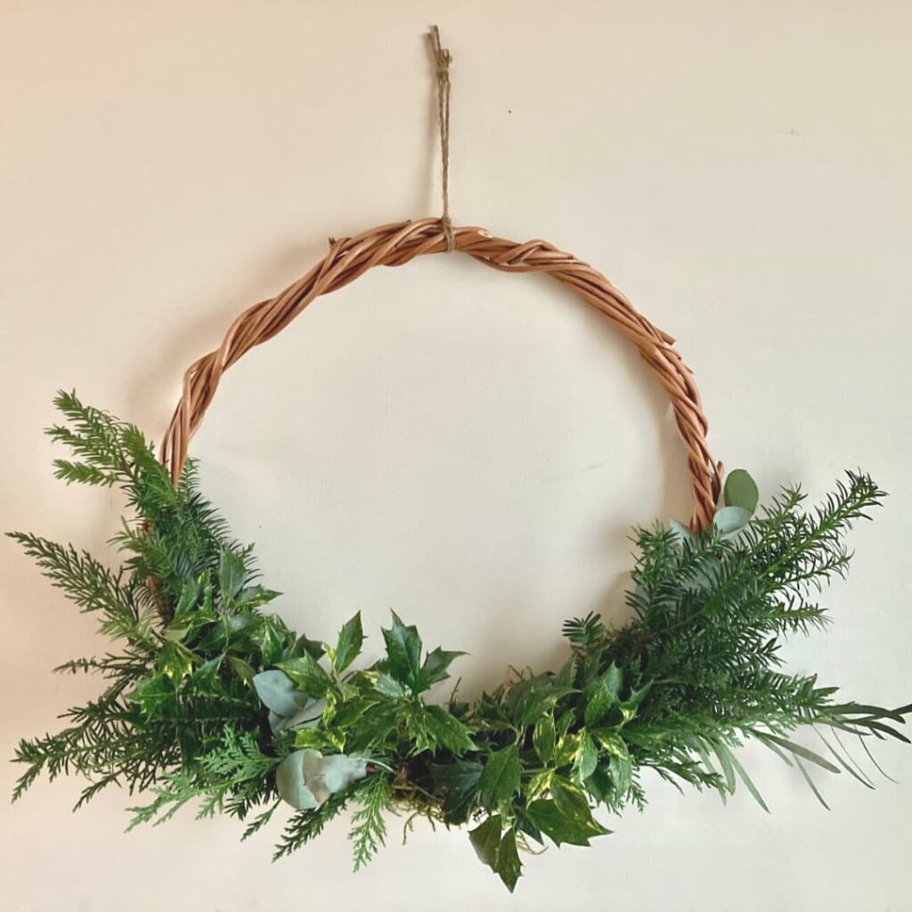 add foliage to wreath base