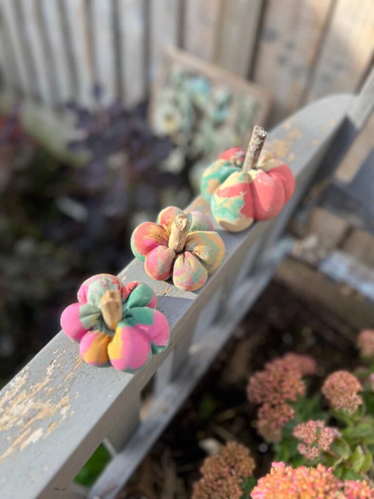 close up of concrete pumpkins painted in rainbow colours