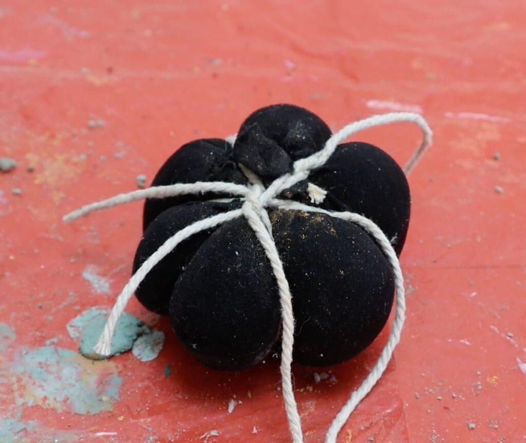 wrap concrete pumpkin with string