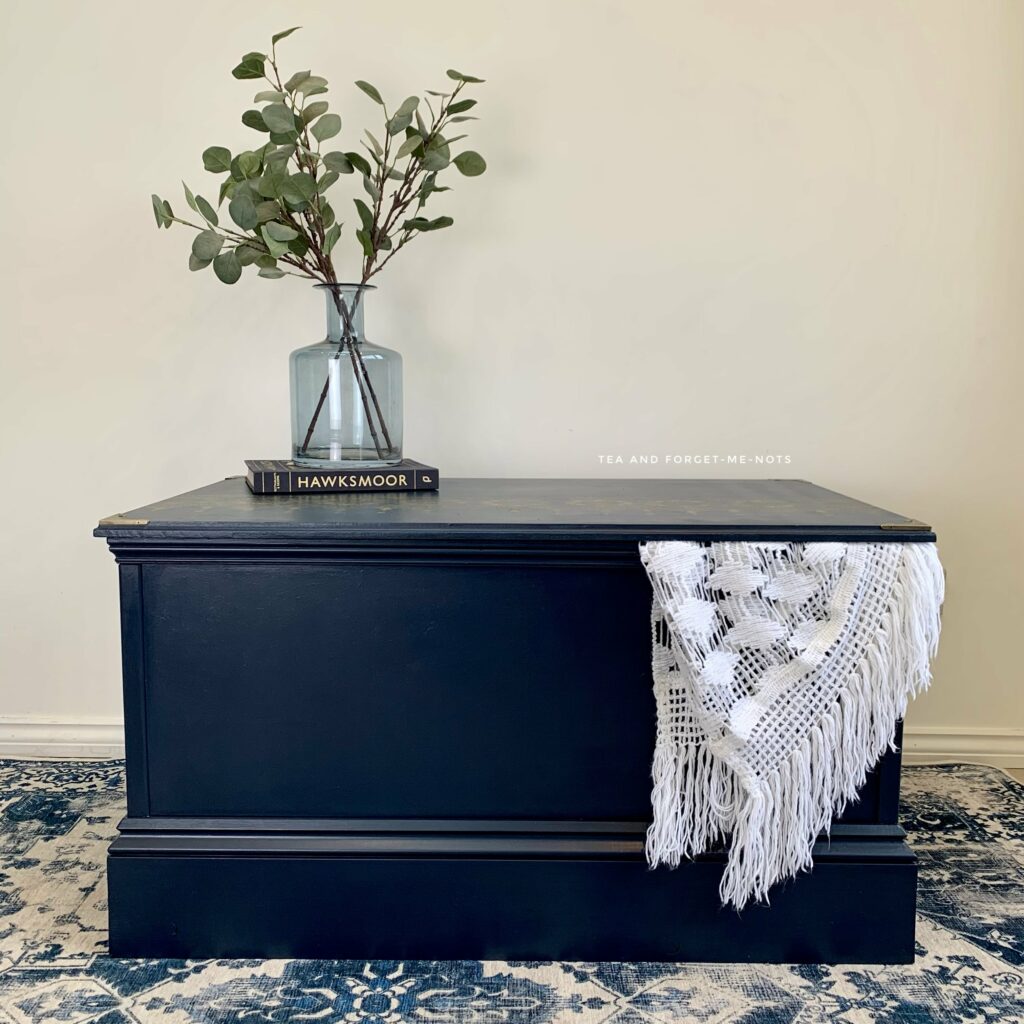 painted mdf chest decorated with vase and blanket.