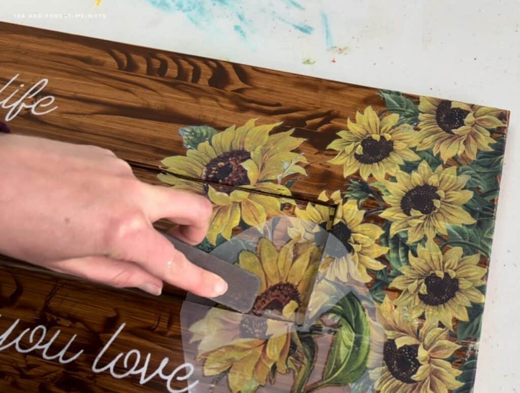 image shows sign decorated with sunflowers. 