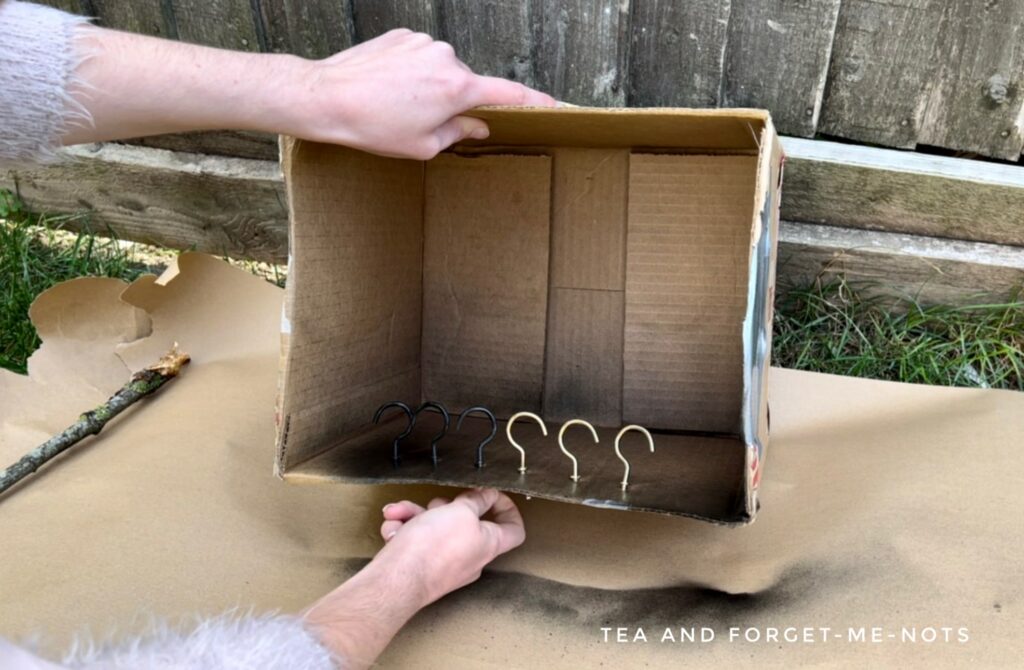 Painting the hooks for the Coat rack