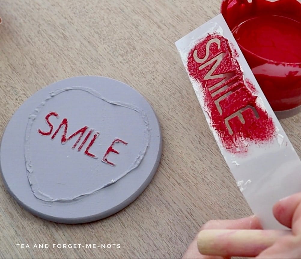 Painting the raised stencil on the valentines heart coaster