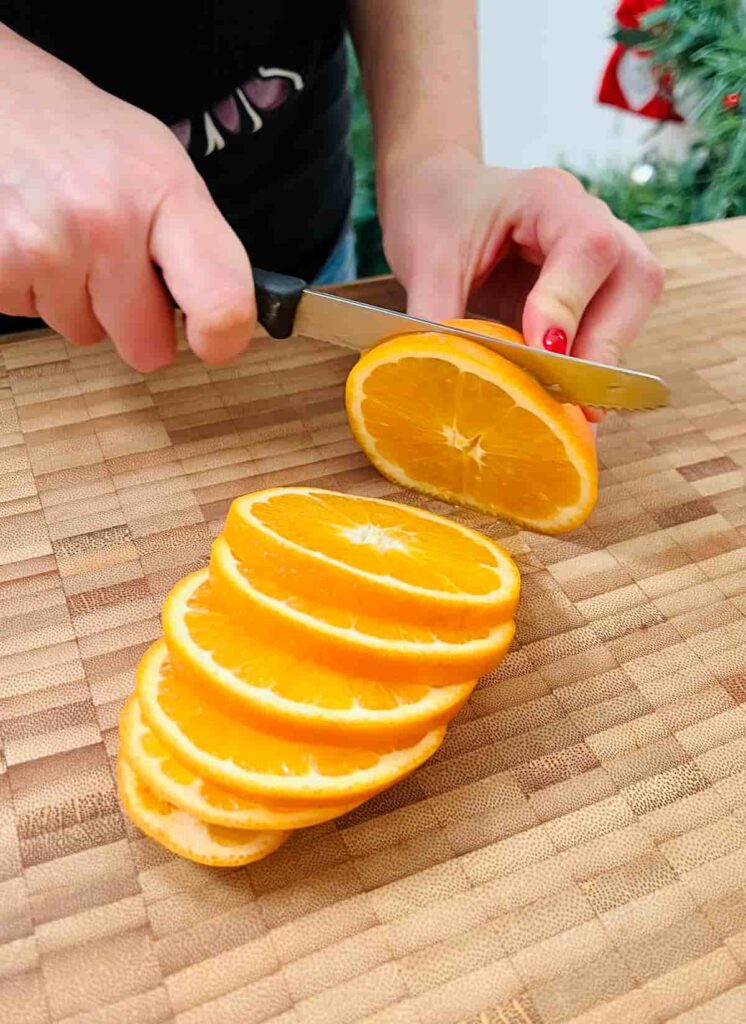slicing oranges before drying