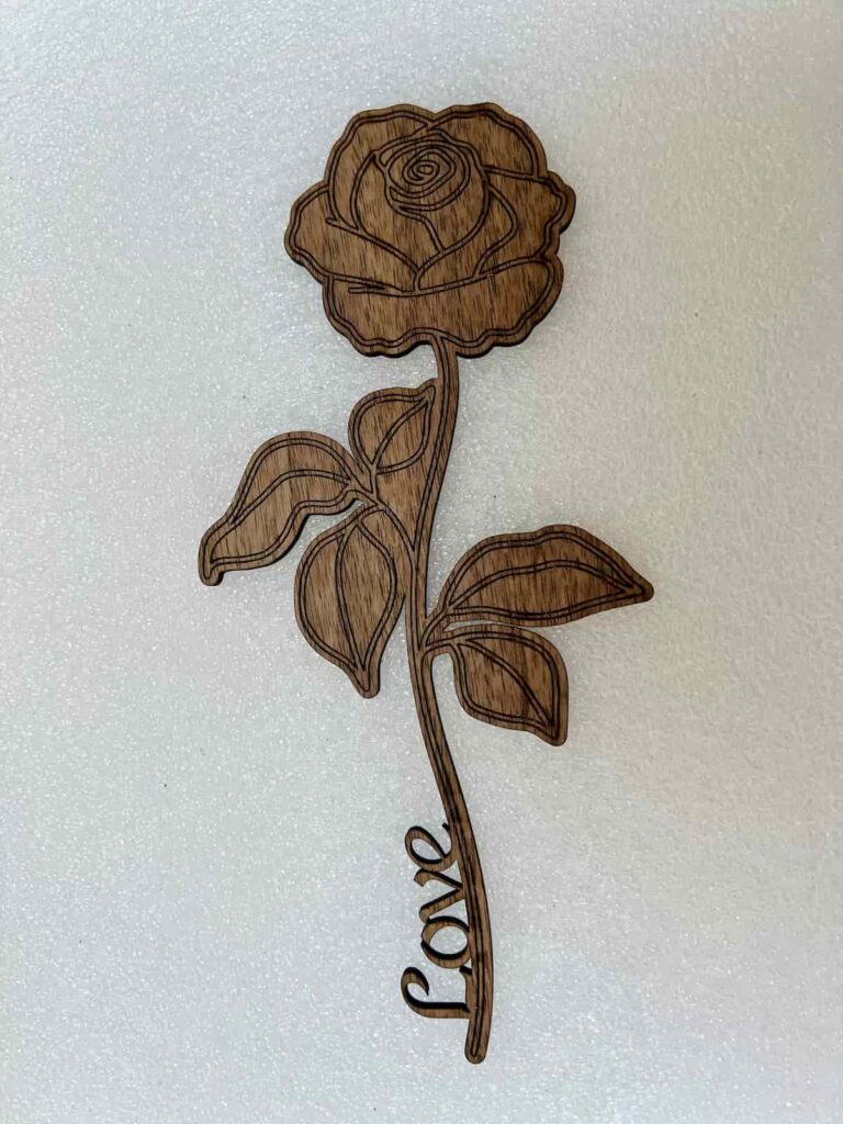 laser cut rose with the word 'love'.