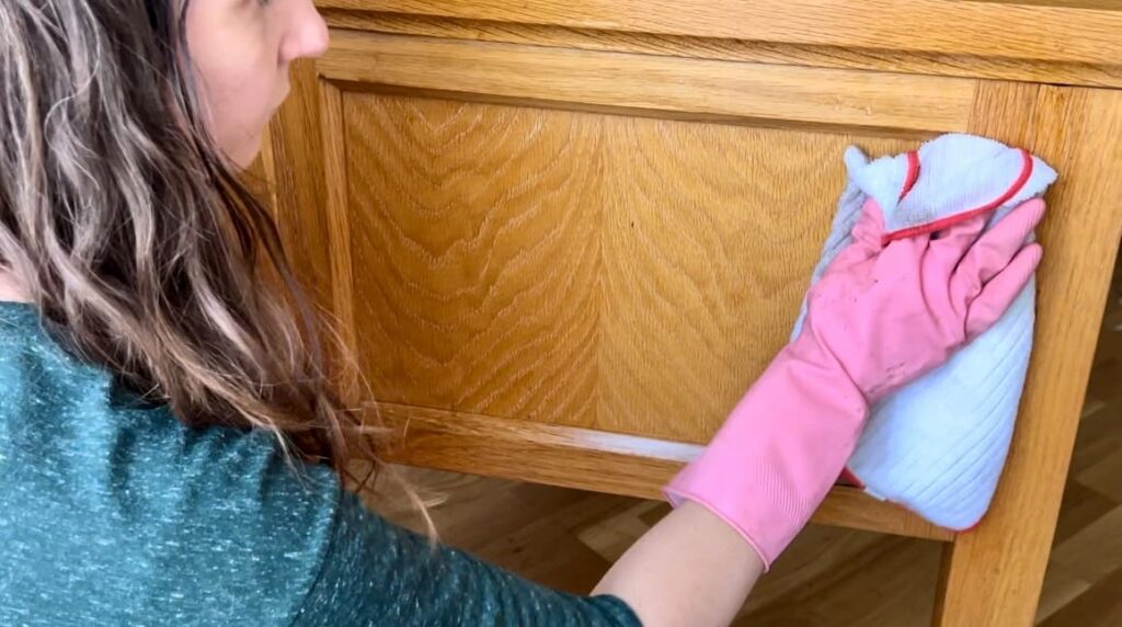 image shows Rachel cleaning the desk with a cloth