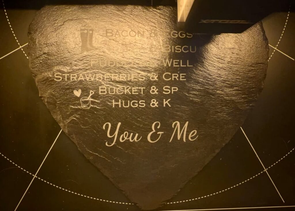 image shows slate being engraved in machine.