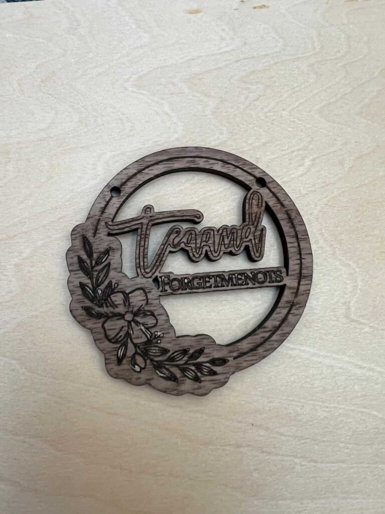 images shows the test cut of a necklace cut on walnut plywood.