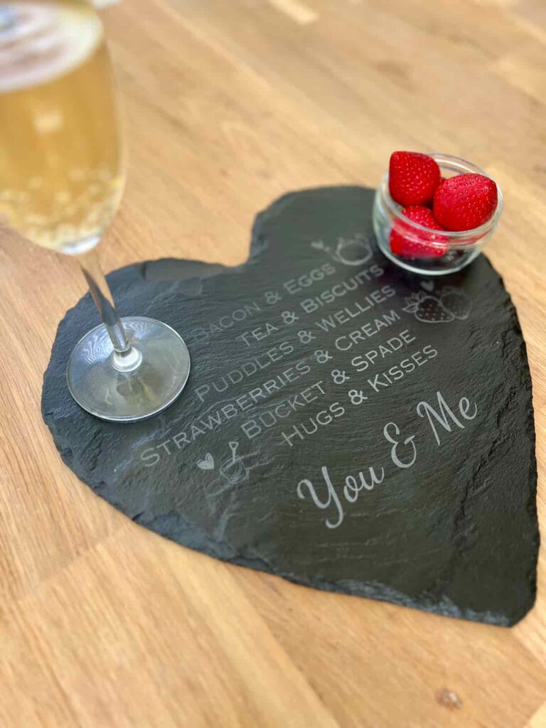 valentines gift engraved slate with drink and strawberries on top.