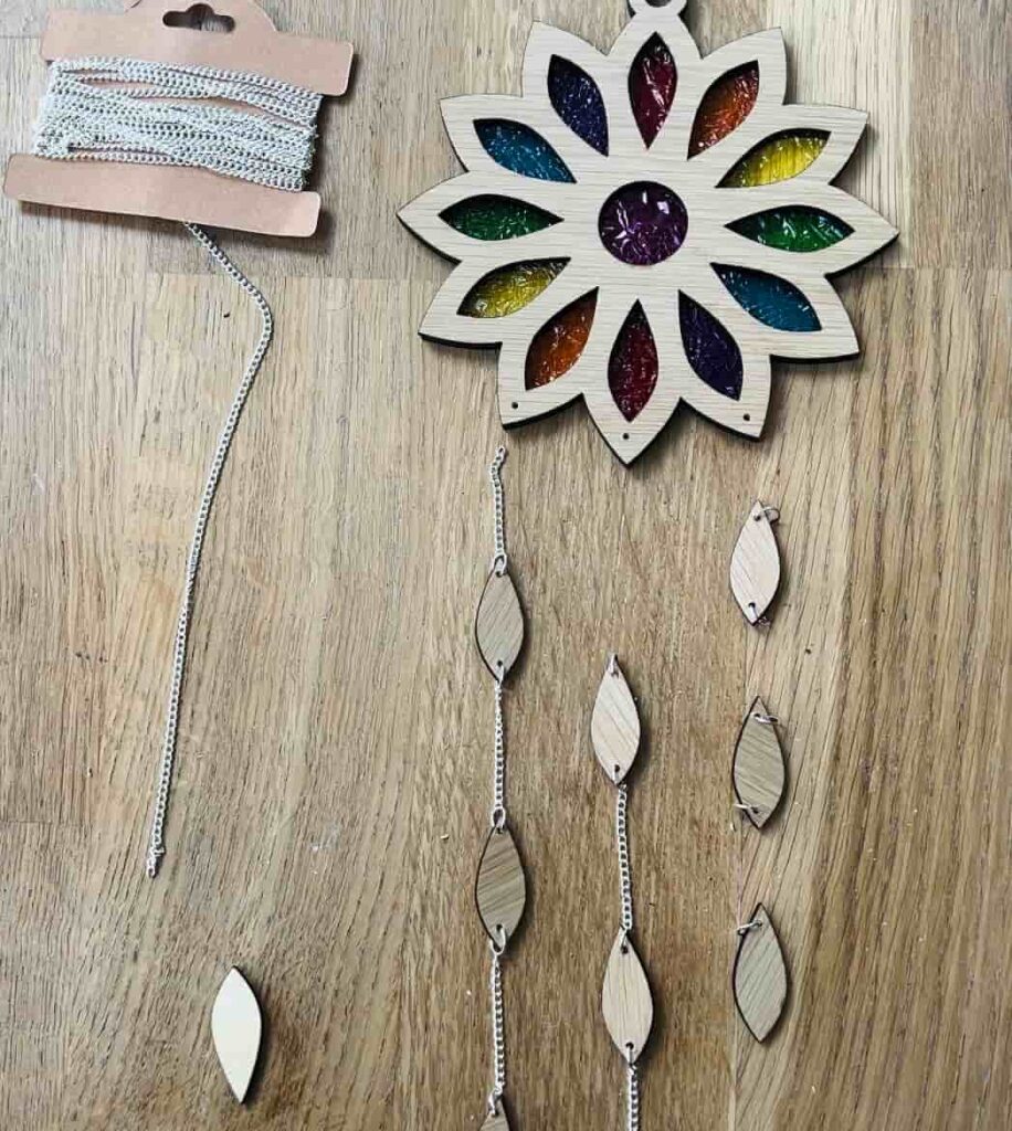 image shows using chain and jump rings to attach raindrop shapes to suncatcher.