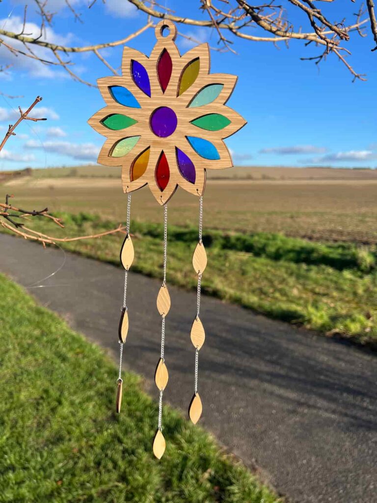 suncatcher hanging in the tree made with candy wrappers.