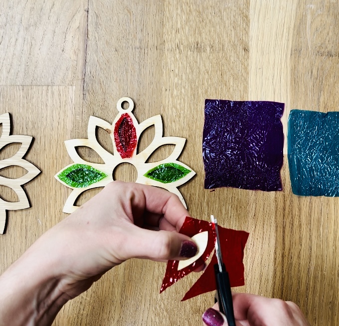 image shows cutting out each chocolate wrapper to fit into flower shape.