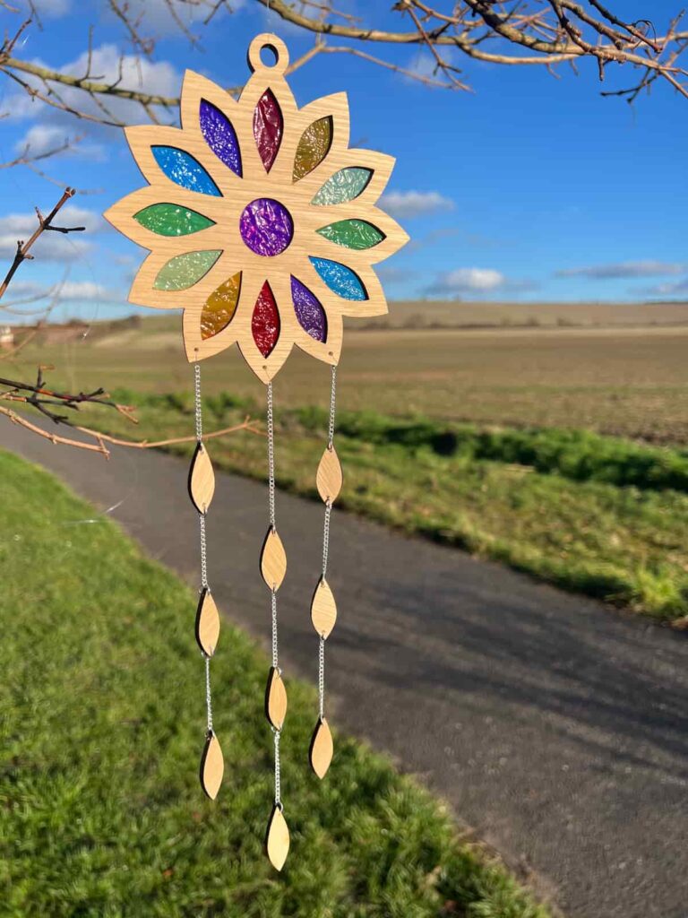 suncatcher with coloured windows hanging from a tree.