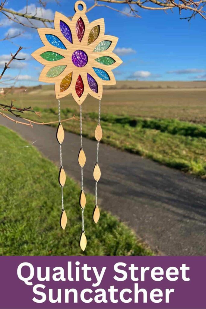 image shows suncatcher hanging from a tree.