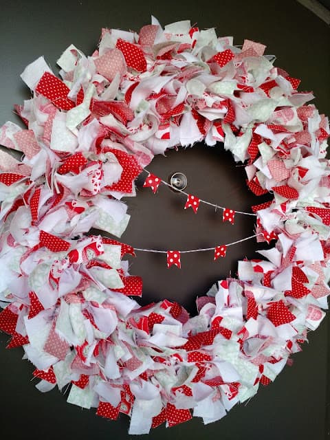 image shows red and white wreath made from rags.