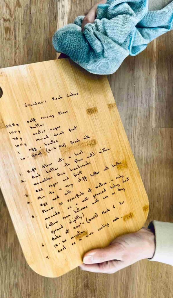 image shows using a cloth to apply hemp oil to chopping board.