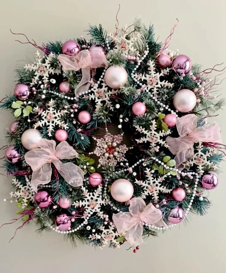 image shows green wreath made up of bows and stars.