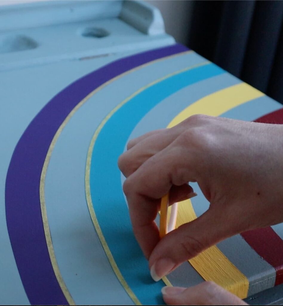 image shows applying masking tape over rainbow.