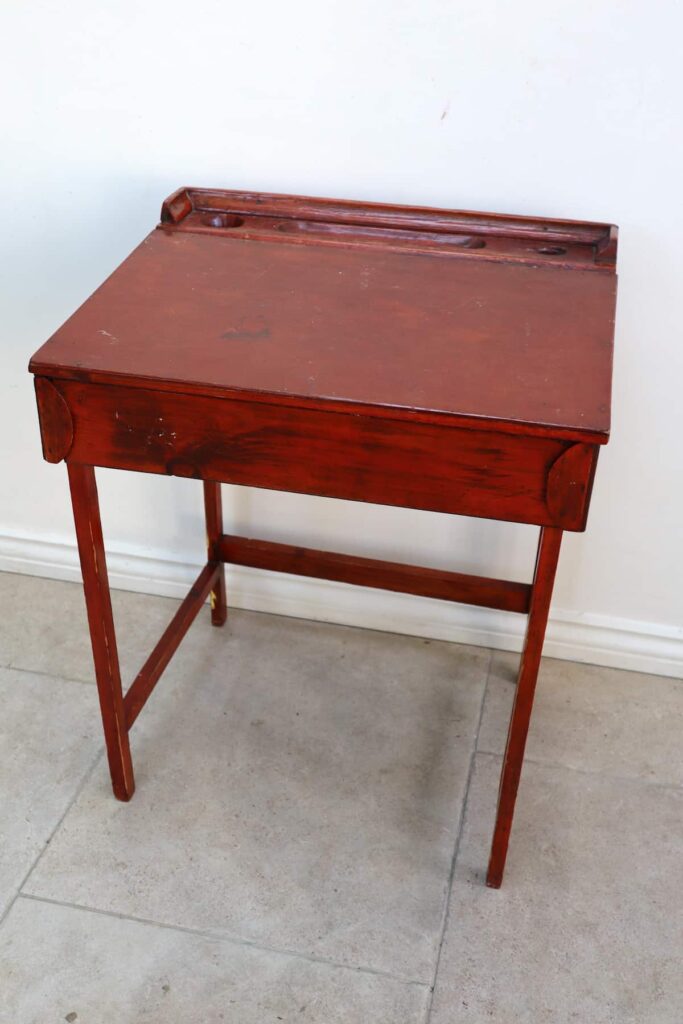 image shows vintage looking brown desk.