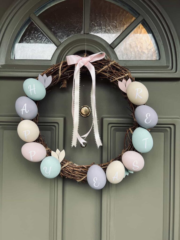 image shows easter egg wreath on green front door.