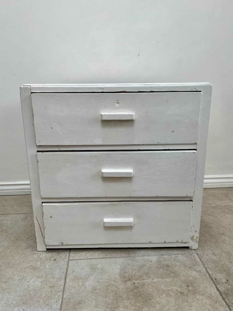 image shows an old painted chest of drawers.