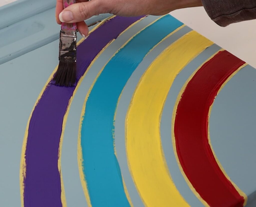 image shows painting the stripes on a rainbow.