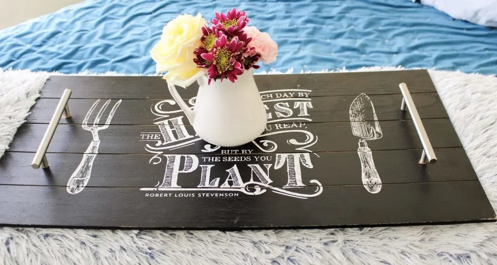 image shows serving tray with vase and flowers.