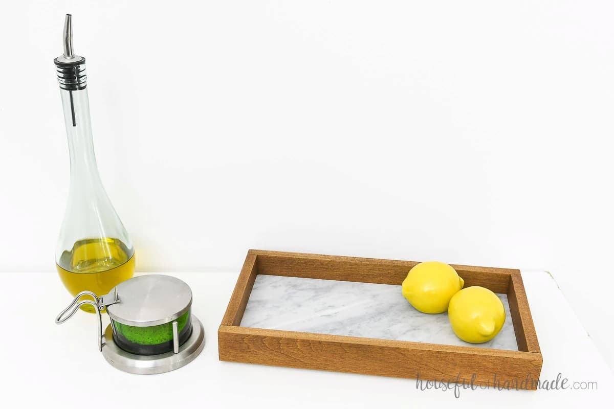 image shows tray with lemons and oil.