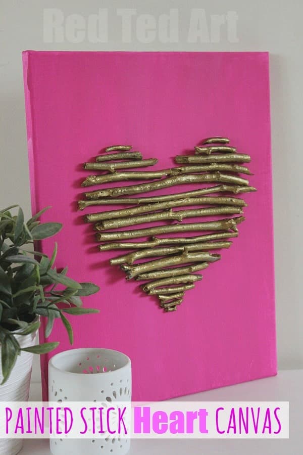image shows pink canvas with sticks in heart shape.