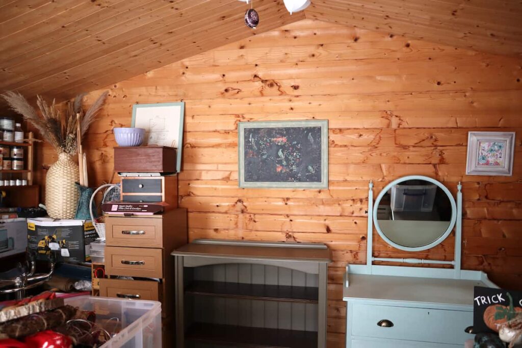 image shows shed filled with furniture.