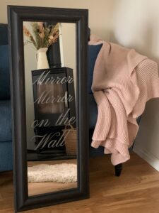 Photo of finished mirror with the words mirror mirror on the wall stencilled