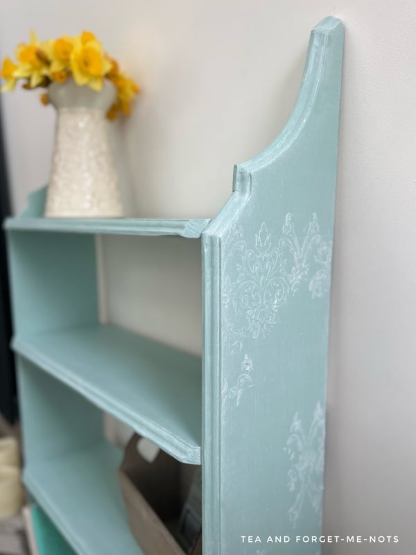 Side view of bookshelf with raised stencil