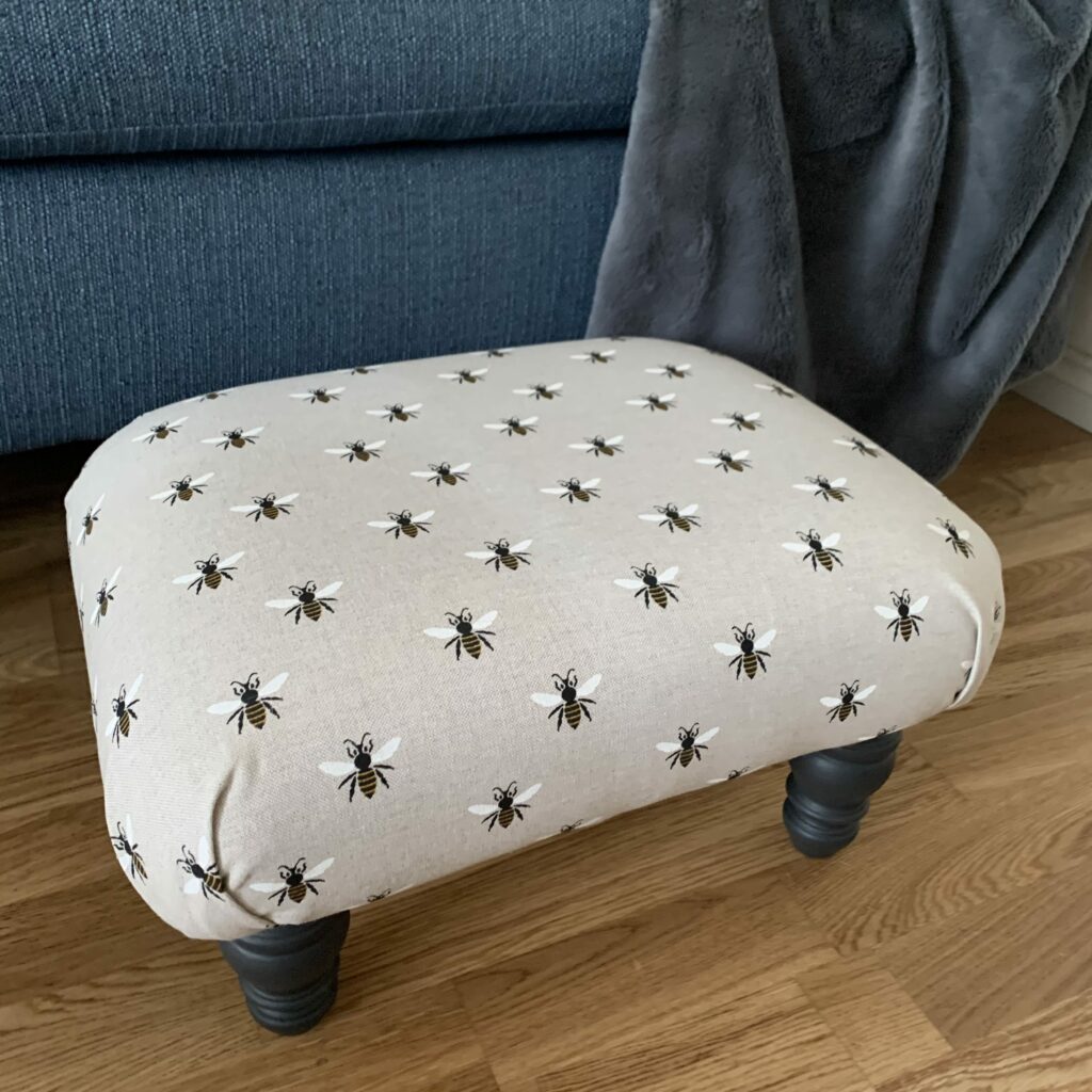 image shows footstool with bee fabric.