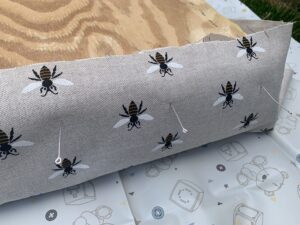The fabric pinned to the stool