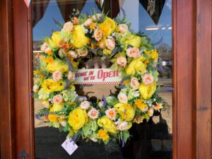 Door wreath saying come in we’re open