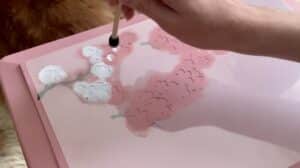 Paint a layered stencil of the white flowers