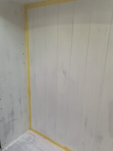 Using frog tape to protect the edges from the paint