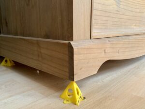 Pyramids used under a chest of drawers - tools under £15