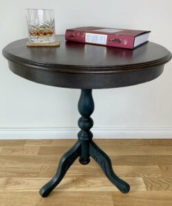 Finished table staged with a drink and book 