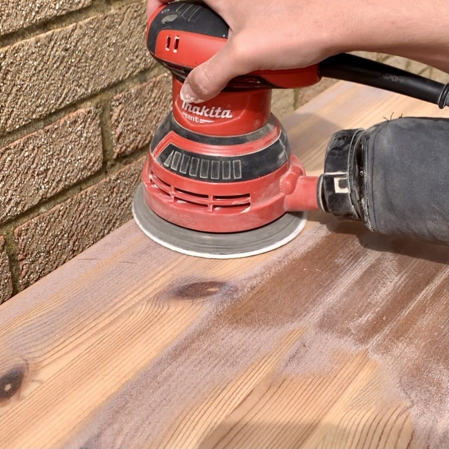 Sanding the top of the boring bookshelf makeover 