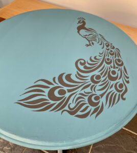 The peacock stencil on top of the table 