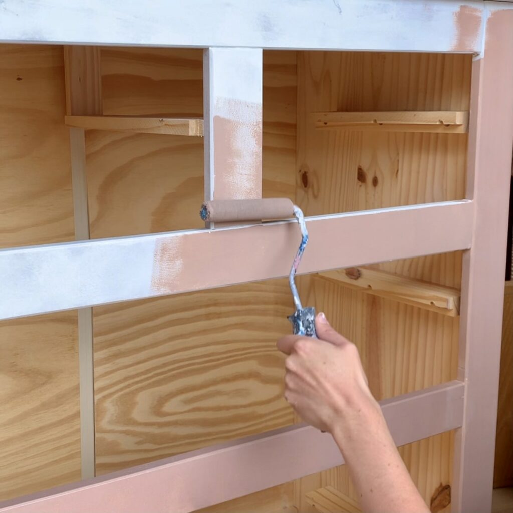 Starting to paint the pink chest of drawers with the first coat of Damask