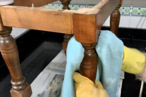 Cleaning with a micro fibre cloth  black wax on furniture 