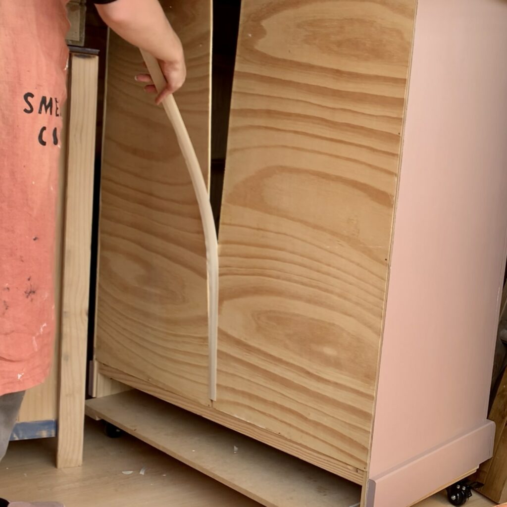 Removing the backing as it had popped out of alignment on the pink chest of drawers 